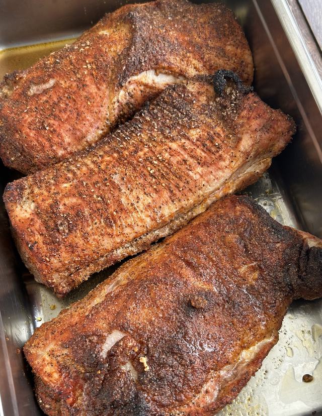 Dry rubbed pork shoulders with a dark barbecue crust