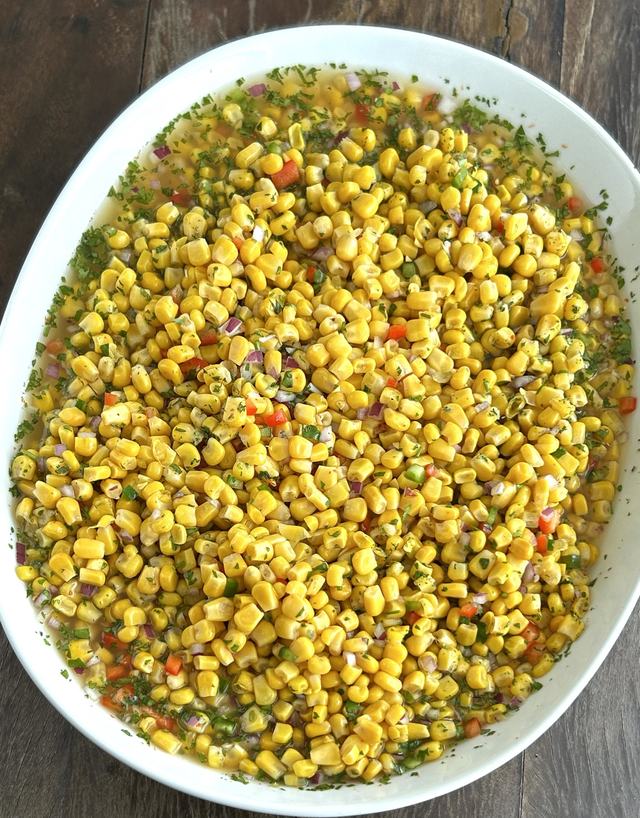 Sweet corn salad with red onion, bell pepper and fresh herbs