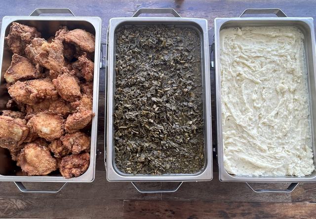 Chafing pans of Southern fried chicken, collard greens and mashed potatoes