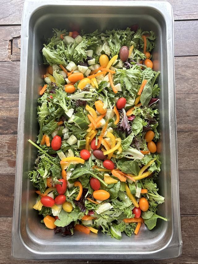 Garden salad with mixed greens, cucumber, bell peppers and grape tomatoes