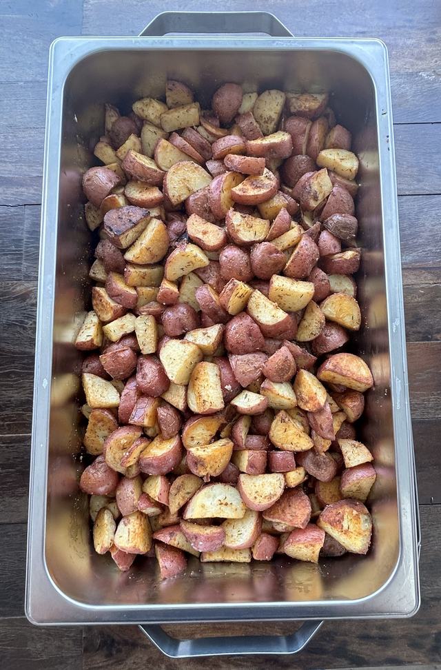 A pan of golden herb roasted red potatoes