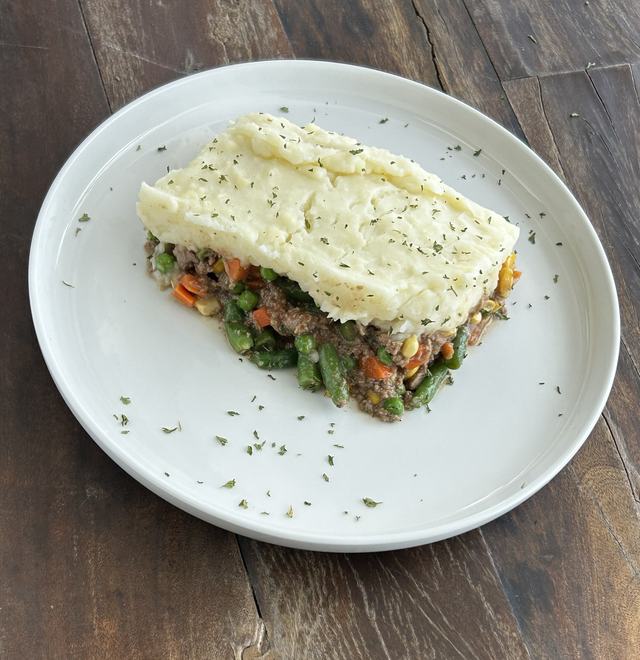 Shepherd's pie with seasoned beef and vegetables under mashed potatoes